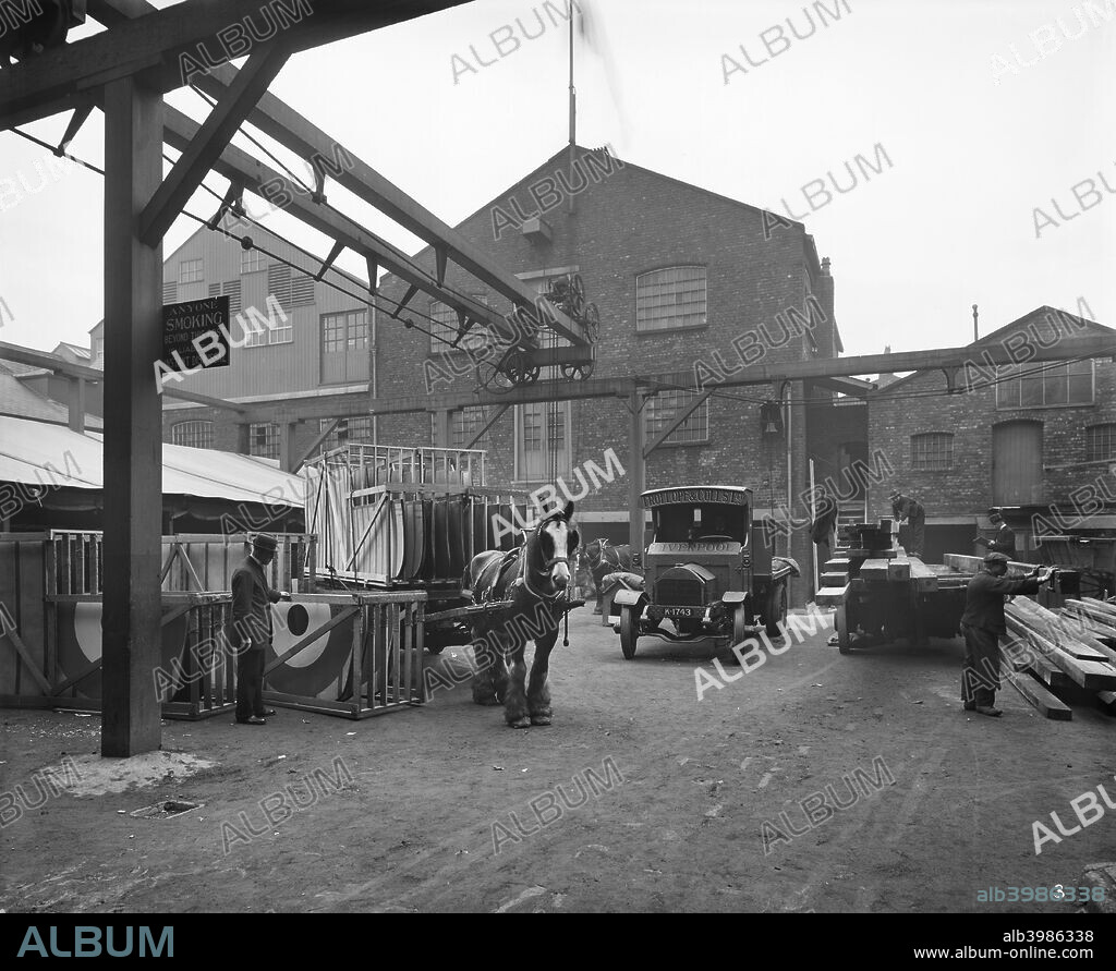 Aircraft manufacturing, Trollope and Colls Ltd, 17-25 Pleasant Street, Liverpool, December 1918. Exterior view of the yard with motor lorries and horse and cart loaded with aeroplane wings. During the First World War builders Trollope & Colls Ltd. converted their timber yard to manufacture wings for biplanes.
