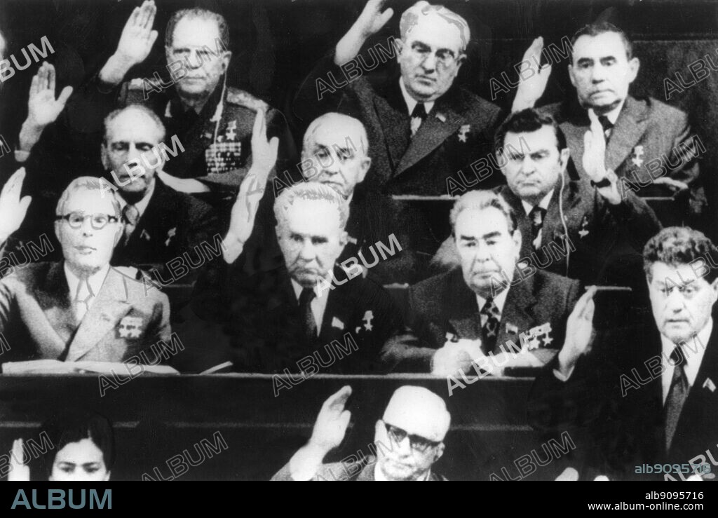 Mr. Brezhnev (second row from bottom, first on the right, only person with no hand up) sitting in Parliament in Moscow 16 June 1977 as members of the Communist Party Politburo voted for him to succeed Mr. Podgorny as president. Leonid Ilyich Brezhnev (December 19, 1906 [O.S. December 6, 1906] - November 10, 1982) was General Secretary of the Communist Party of the Soviet Union (and thus political leader of the USSR) from 1964 to 1982, serving in that position longer than anyone other than Joseph Stalin. He was twice Chairman of the Presidium of the Supreme Soviet (head of state), from 1960 to 1964 and from 1977 to 1982. © TopFoto.
