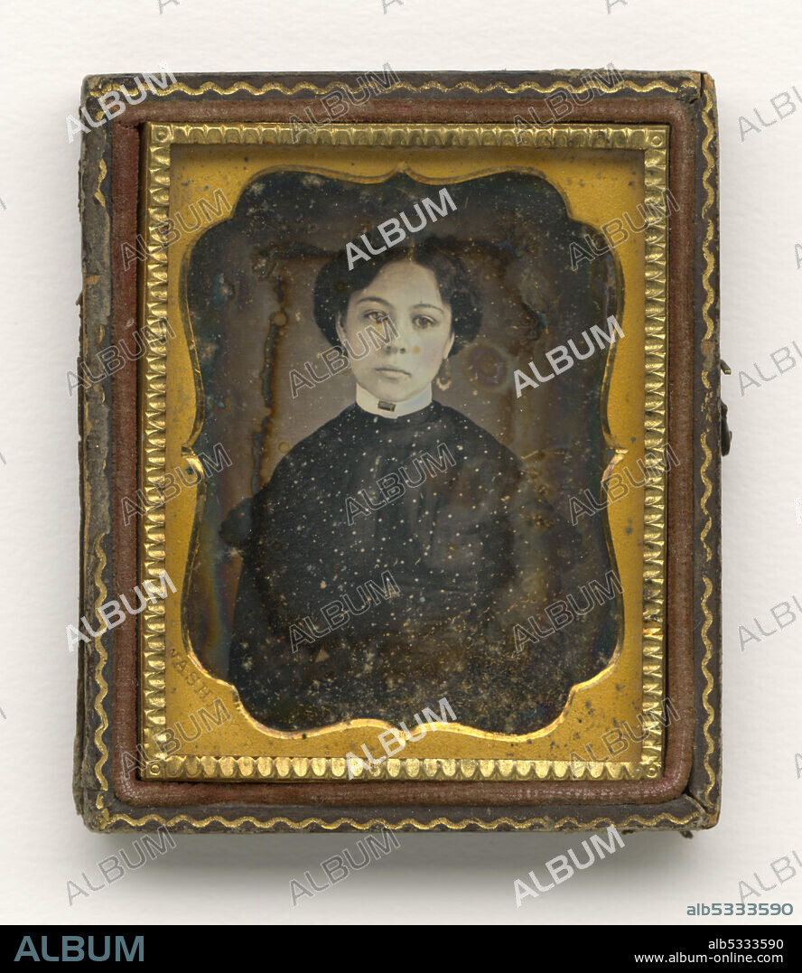 AUGUSTUS WASHINGTON. A black-and-white photograph of a young woman dressed in a high-collared garment and wearing dangling earrings. The earrings have been hand-tinted gold. The plates are in a case that is missing its cover. The photograph has a gold colored frame stamped [WASHINGTON] on the bottom left corner.