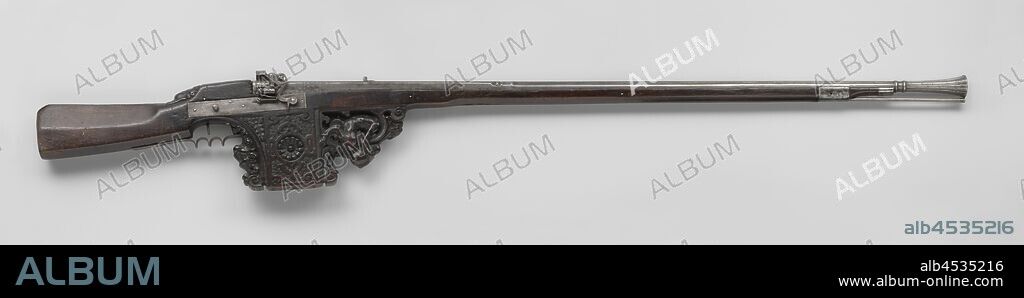 Target rifle with tinder snap lock, Target rifle or rudder. The tinder snap lock has a rectangular lock plate with a rooster on which a tube for the tinder is soldered. The barrel consists of a quadrilateral part that, after a ring, twice stamped with a mark in the form of a key under a crown or finial, runs through a round ring and a second ring, into a chalice-shaped stump showing the remains of a visor grain, equipped with a visor with peephole stamped with an incomplete year. The flask has an octagonal handle and a massive spool under the lock, the sides of which are carved with panels based on the architectural-style decoration of late 16th century book covers, the front and back of the support spool are almost three-dimensional cut and finished with a half-sitting faun with a bagpipe and a large lion's head, instead of a thumb plate, the flask is cut behind the barrel with a cobblestone head. The iron fitting consists of a drawer cap and band made of iron can, a trigger guard molded to the fingers, and a butt plate with a trace over the entire handle, the steel loading stick is, at the earliest, eighteenth-century, rosette, ornament, anonymous, 1620 - 1629, iron (metal), steel (alloy), cutting, l 165.6 cm l 127.3 cm d 13.3 mm w 7.8 kg.