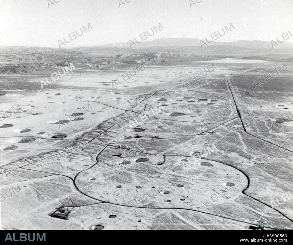 North end of Yucca Flat at the Nevada National Security Site. Most underground nuclear tests were conducted in this valley. Underground testing often leaves visible evidence on the surface in the form of subsidence craters in varying dimensions. Subsidence craters are depressions on the surface that occur when the roof of the blast cavity collapses into the void left by the explosion. The size of the subsidence crater depends on the yield of the device, the depth of emplacement, and the geological characteristics of the surrounding soil. Yucca Flat is a closed desert drainage basin, one of four major nuclear test regions within the Nevada Test Site (NTS), and is divided into nine test sections: Areas 1 through 4 and 6 through 10. Yucca Flat is located at the eastern edge of NTS, about ten miles north of Frenchman Flat, and 65 miles from Las Vegas, Nevada. Yucca Flat was the site for 739 nuclear tests and has been called "the most irradiated, nuclear-blasted spot on the face of the earth".