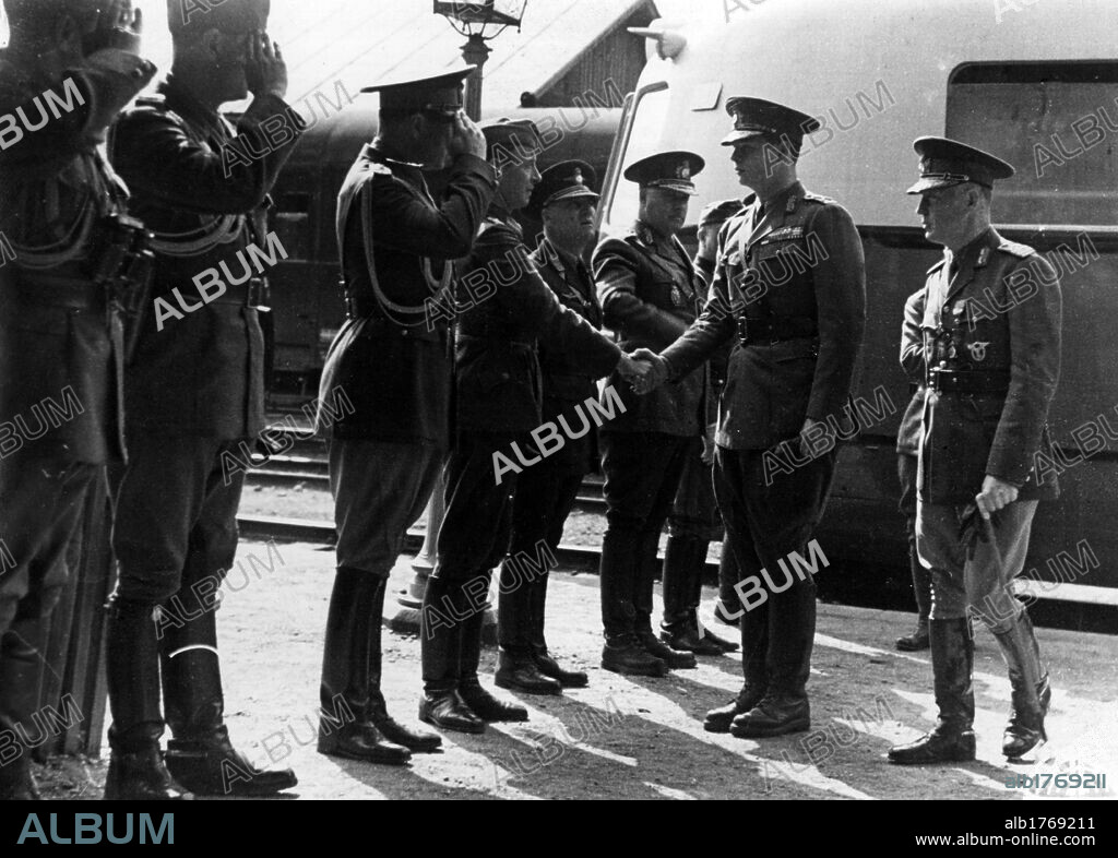 Ion Antonescu and Michael I of Romania shake hands with senior officers. Romanian Prime Minister Ion Antonescu and King Michael I of Romania shake hands with the officers of the General Staff on their arrival at the railway station of Cernauti (Chernivtsi). Cernauti, July 1941.