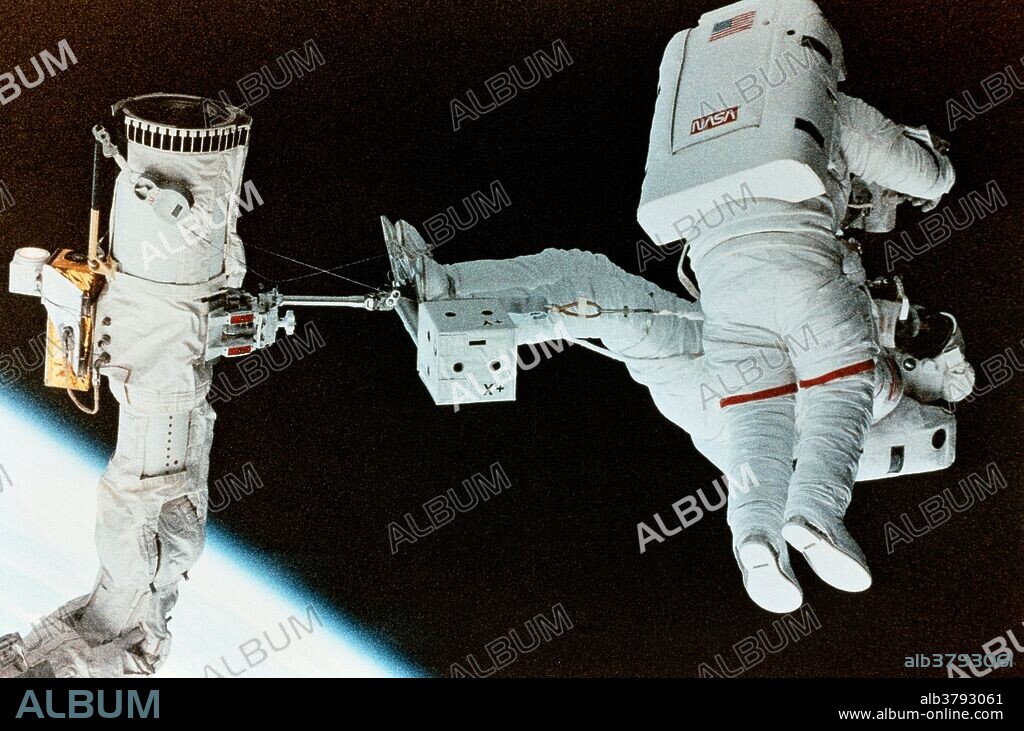 Shuttle astronauts on EVA (STS-63 onboard view). Astronaut Bernard A. Harris Jr., payload commander, standing on a foot restraint attached to the Remote Manipulator System (RMS) arm carrying astronaut C. Michael Foale, mission specialist, during their shared extravehicular activity (EVA) in the space shuttle Discovery's cargo bay.