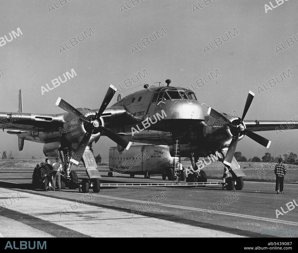 For towing the plane portion of the new Fairchild XC-120 Packplane without its cargo-carrying fuselage, a long bar extends between the two nose wheels to provide easier turning and steering. This bar is not used in taxiing or landing the plane. October 01, 1950. (Photo by Virts, Fairchild Aircraft).;For towing the plane portion of the new Fairchild XC-120 Packplane without its cargo-carrying fuselage, a long bar extends between the two nose wheels to provide easier turning and steering. This bar.