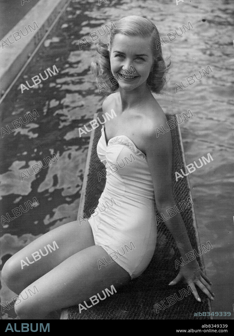 Rose Marie Takes A Cooler -- Barbara Ann Scott star of Rose Marie on Ice, now showing at Harringay Arena, is seen at the "Oasis" Swimming Pool, Holborn, taking a rest in between shows. July 10, 1951. (Photo by Daily Mirror).