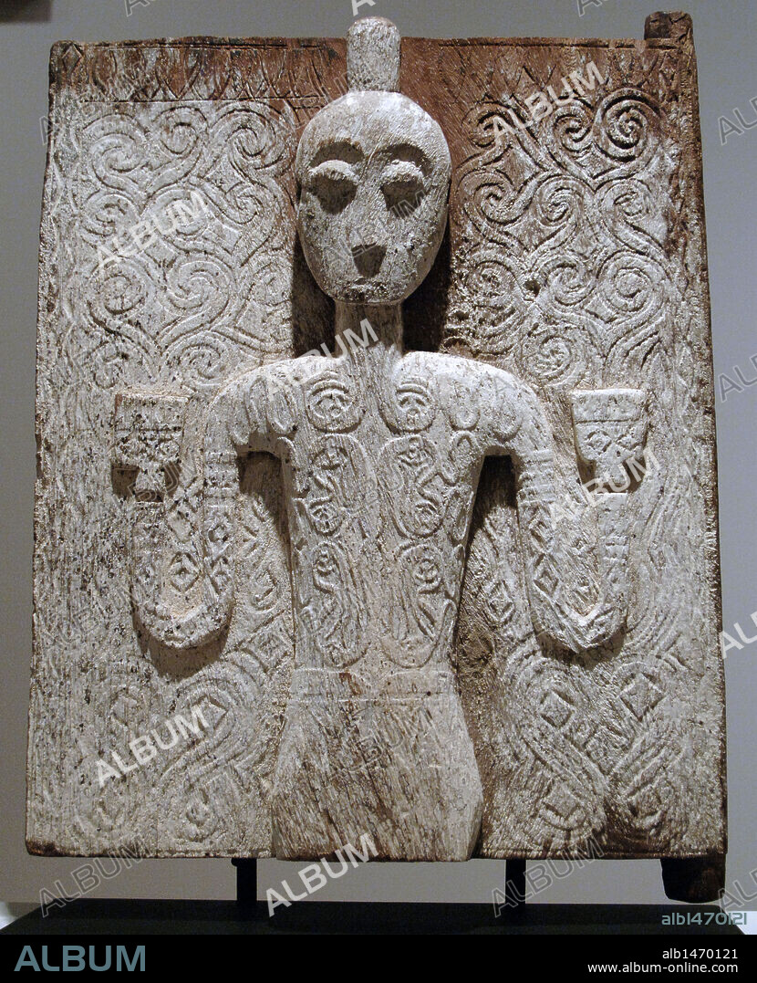 Wooden door of a tomb with human figure. Sa'dan Toraja people. Guardian figure on this door represents a warrior, as indicated by his topknot and tattoos. 18th or 19th century. Wood and dead lichen. South Sulawesi, Indonesia. Dallas Museum of Art. State of Texas. United States.