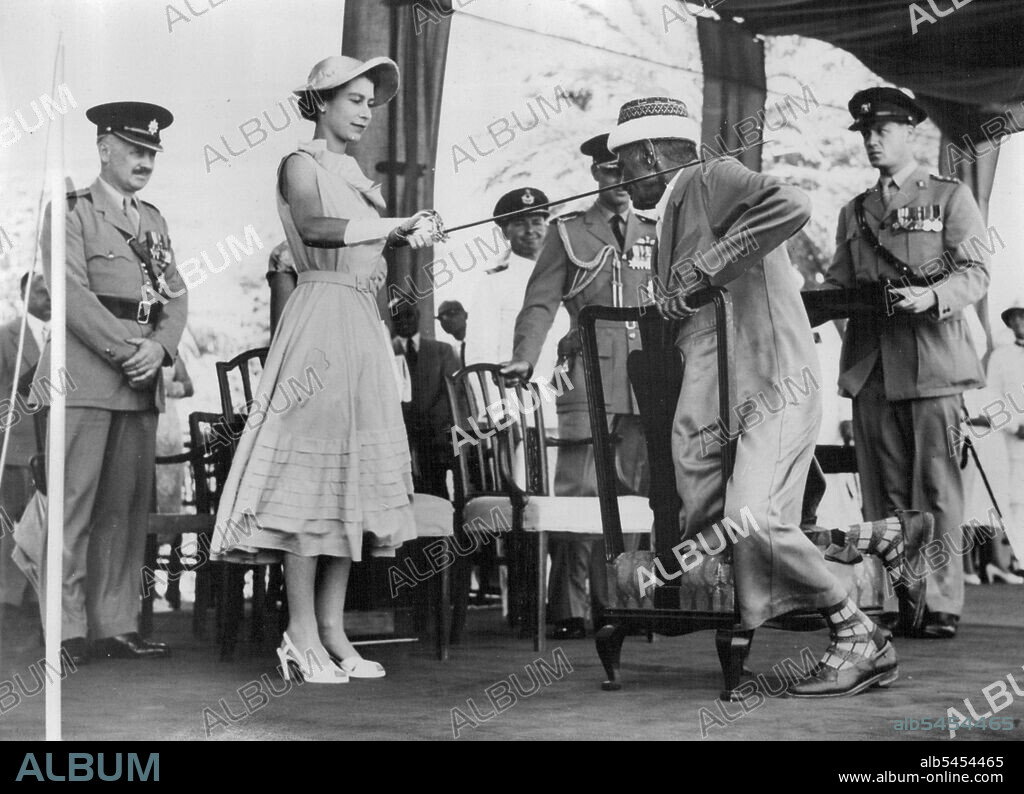 The Queen Knights A Sheikh -- The Queen gives the traditional tap on the shoulder with a sword to Senid Bubaker Bin Sheikh Al Kaf, Councillor of the Kathiri State, when she knighted him during the ceremonies at Aden yesterday. April 28, 1954.