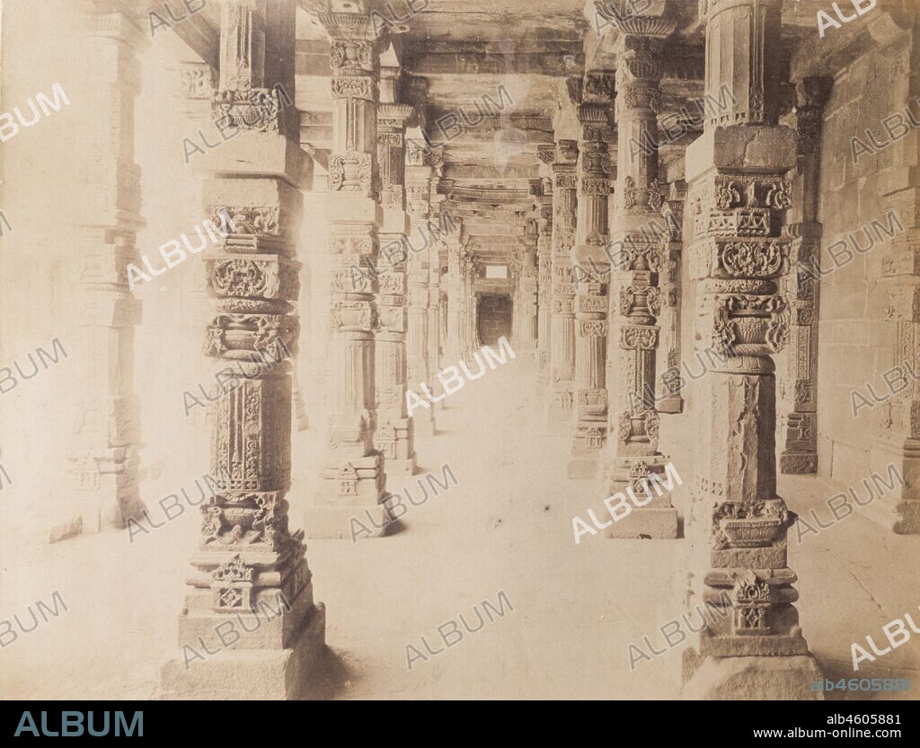 India, Intricately carved stone pillars line a passageway at the Quwwat-ul-Islam Mosque. Original manuscript caption: Stone pillars at the Kutub near Delhi, circa 1890. 2003/071/1/1/2/57.