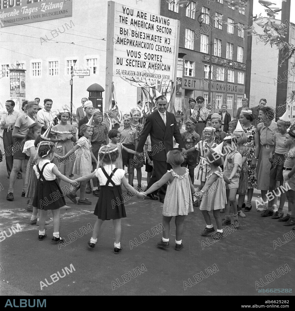 The district mayor of Berlin-Kreuzburg, Willy Kressmann, celebrates a children's festival with East and West Berlin children at the sector border between Berlin-Kreuzberg and Berlin-Mitte, in 1954. 1954