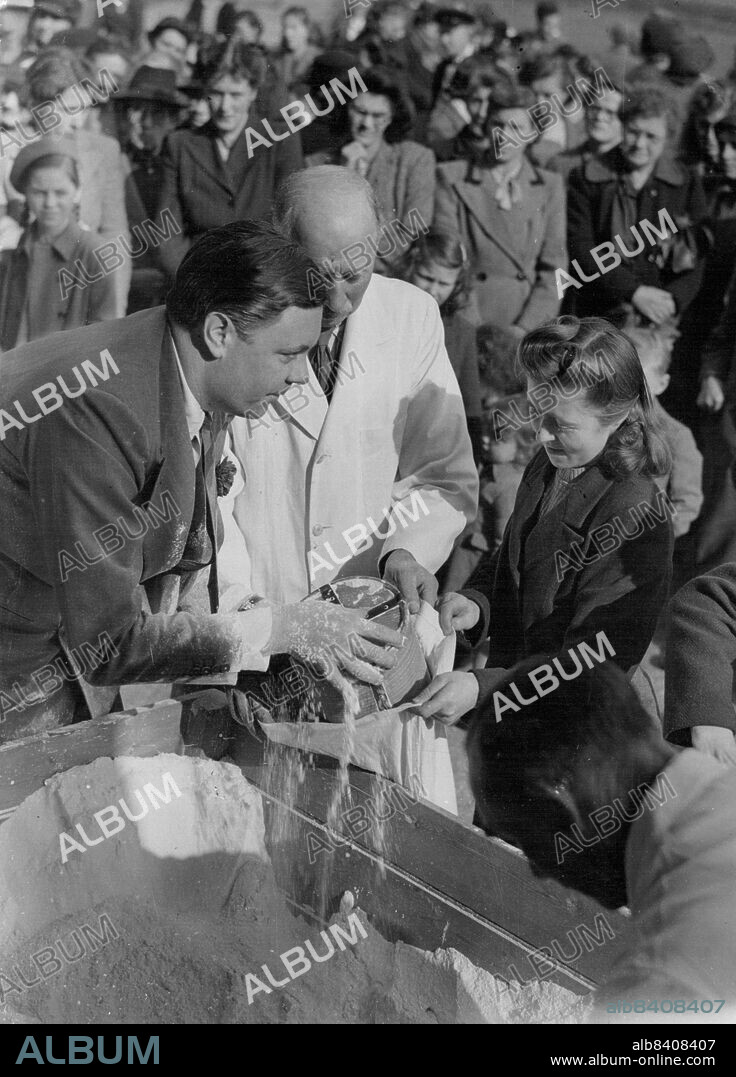 The Tichborne (Flour) Dole - Sir Anthony Doughty Tichborne, fourteenth baronet, doling out flour to one of the 989 tenants entitled to receive it under terms of the legendary Tichborne Dole in the annual ceremony outside the Tichborne Manor, home of the Tichborne Family, when each man received one gallon, and women and children half-a-gallon of flour from a large container at the ancient custom, traditionally give to the 'poorest' villagers by present-day head of the Tichborne family - whose ancestor, the first Lady Tichborne, instituted the gift centuries age. March 26, 1949.