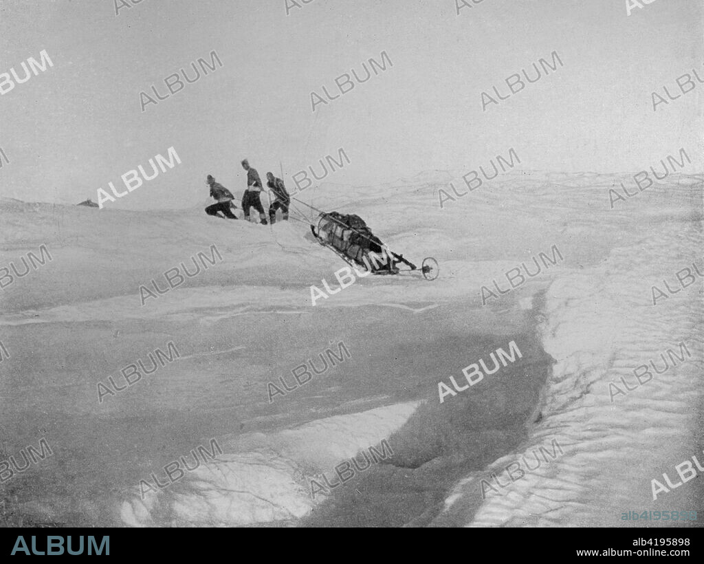 'Overland Over Cape Roberts' To Avoid The Screw-Pack. The Sledge has just crossed the tide crack, here twenty feet wide, between the sea-ice and the land-ice', c1911, (1913). The final expedition of British Antarctic explorer Captain Robert Falcon Scott (1868-1912) left London on 1 June 1910 bound for the South Pole. The Terra Nova Expedition, officially the British Antarctic Expedition (1910-1913), included a geologist, a zoologist, a surgeon, a photographer, an engineer, a ski expert, a meteorologist and a physicist among others. Scott wished to continue the scientific work that he had begun when leading the Discovery Expedition to the Antarctic in 1901-04. He also wanted to be the first to reach the geographic South Pole. Scott, accompanied by Dr Edward Wilson, Captain Lawrence Oates, Lieutenant Henry Bowers and Petty Officer Edgar Evans, reached the Pole on 17 January 1912, only to find that the Norwegian expedition under Amundsen had beaten them to their objective by a month. Delayed by blizzards, and running out of supplies, Scott and the remainder of his team died at the end of March. Their bodies and diaries were found eight months later. From Scott's Last Expedition, Volume II. [Smith, Elder & Co., London, 1913].