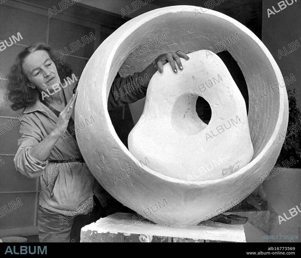 Britain's leading woman sculptor Barbara Hepworth is seen with a new work 'Sphere and the Inner Form' on which she is engaged in her studio in St Ives, Cornwall. This particular piece will be included in an exhibition of her work in Switzerland in November.