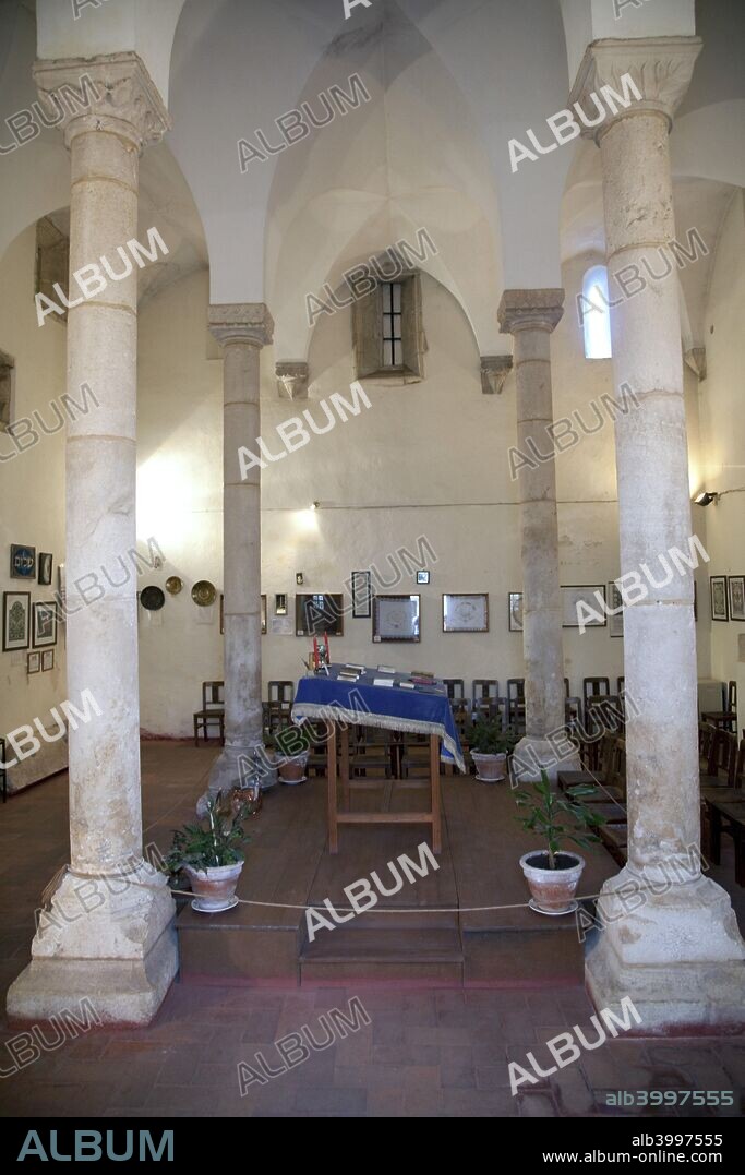 The synagogue of Tomar, Portugal, 2009. The synagogue of Tomar is the best preserved of the mediaeval synagogues of Portugal. It is located in the historic centre of the city of Tomar and houses a small Jewish Museum. Tomar was founded in the 12th century as the headquarters of the Knights Templar in Portugal. In order to establish an easy cohabitation between the town and the Convent of the Knights of Christ, the castle was built in three distinct walled enclosures, surrounded by an extensive outer wall. The largest enclosure, which faced southwards, was the walled town, whose gateway overlooked the area known as Sete Montes. In the 16th century the town was emptied of its inhabitants and transformed into kitchen gardens and orchards for the monks of the Order of Christ. In recent times the vegetable gardens have been replaced by the Parque do Laranjal, where can be found evidence of the old town in the stones of the doorways and windows that have been preserved by time. The Templar Castle and the Convent were declared a World Heritage Site by UNESCO in 1983.