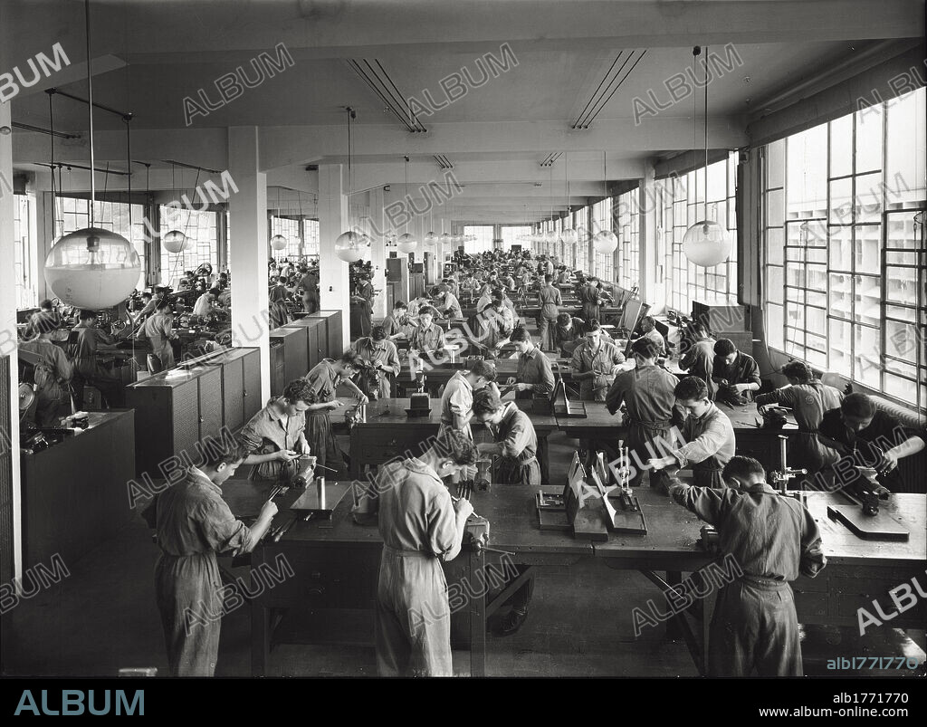 Young Olivetti's workers. Italian workers working in Olivetti's mechanical training center workshop. Italy, 1950s.