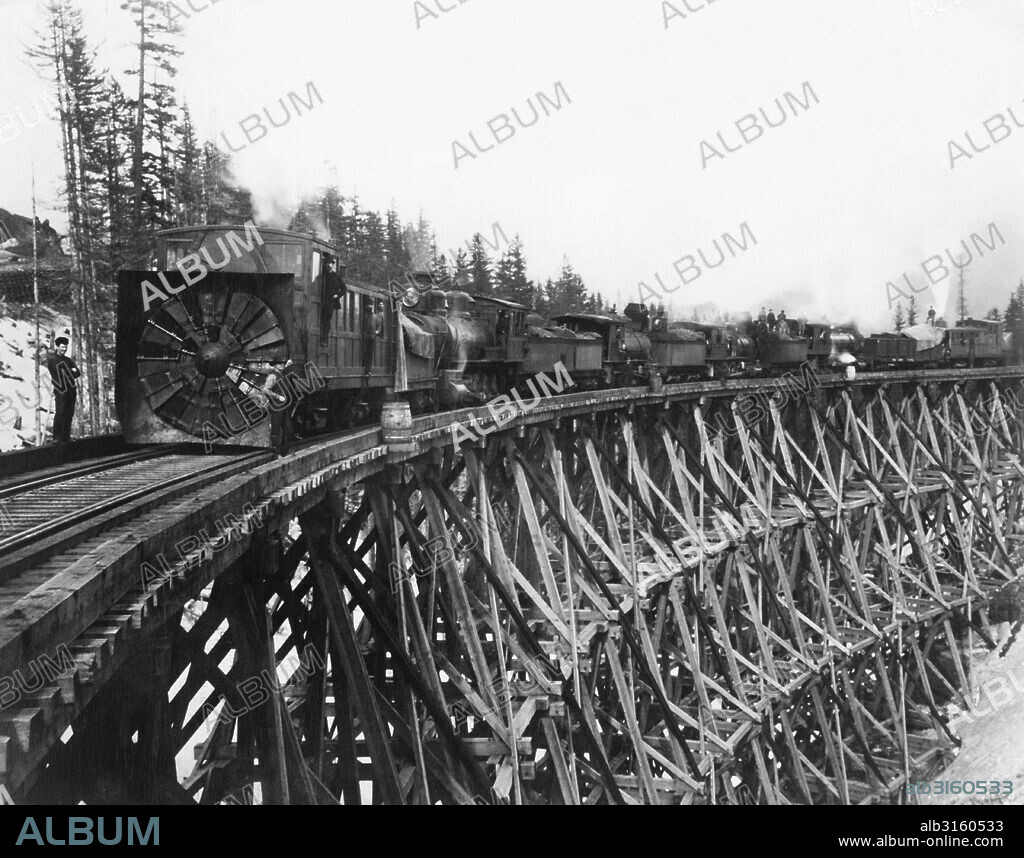 Easton, Washington: 1887 Northern Pacific Railroad's rotary snow plow on Bridge #1 over Mosquito Creek in the Cascades mountains. Note the plows on both ends of the train.