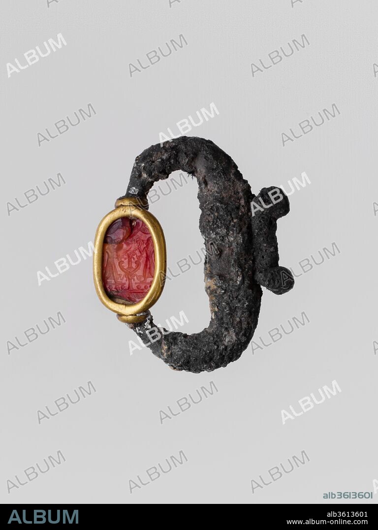 Silver pendant with carnelian scarab. Culture: Cypriot or Phoenician. Dimensions: Other: 5/16 × 9/16 × 11/16 in. (0.8 × 1.4 × 1.7 cm)
Diameter: 1 11/16 in. (4.3 cm). Date: 6th-5th century B.C..
On the scarab, two figures flanking a tree.
This type of pendant, that undoubtedly also served an amuletic function, was Phoenician in origin and widely distributed throughout the Mediterranean.