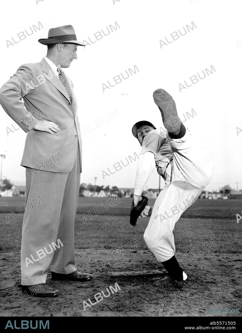One-Man Double Play -- Here Cameron Mitchell shows Dan Crowley how he throws a fast one.Cameron Mitchell, 28-year-old contract Movie Actor, has turned down a pitching contract with the Detroit Tigers. He won the Baseball offer when he pitched a 20-1 victory for the Culver Palms Semi Pro Baseball Club. In the stands was Dan Crowley, Tigers scout, who was so impressed by Mitchell's action on the mound that after the game he came up with a contract, effective immediately. The young actor turned turned down the chance, to stick to his seven-year contract with MGM. he has a featured role as the Navigator in "High Barbaree," and now is working in "Cass Timberlane." In his spare time, he has been leading the Culver team to victories in the Los Angeles area. May 28, 1947. (Photo by Wide World Photo).