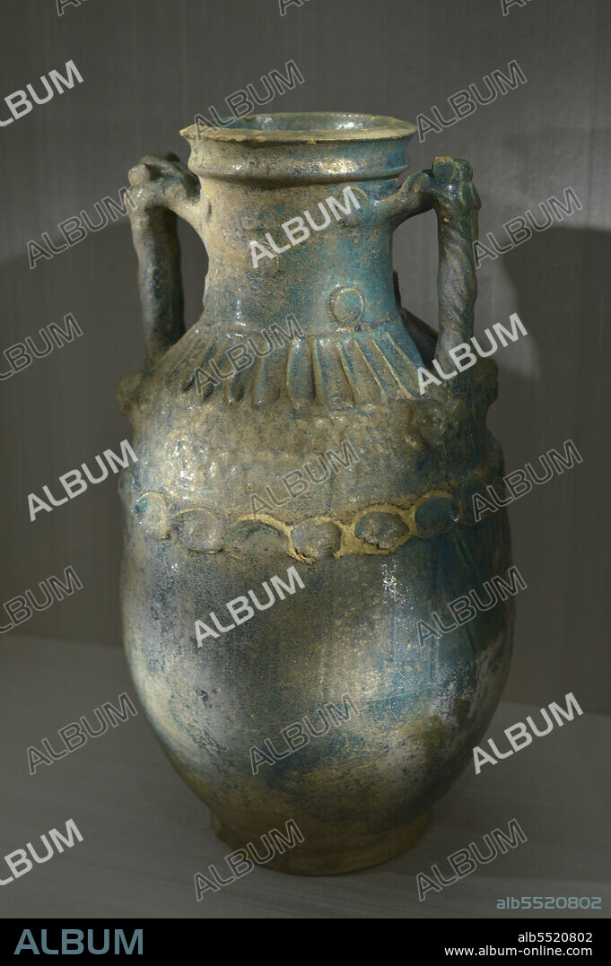 Parthian vase. 1st century BC-1st century AD. Funerary vase decorated with a chain of medallions and four masks depicting the deities of the netherworld. Hellenistic influence. Parthian Empire (247 BC-224 AD). Glazed pottery. Calouste Gulbenkian Museum. Lisbon, Portugal.