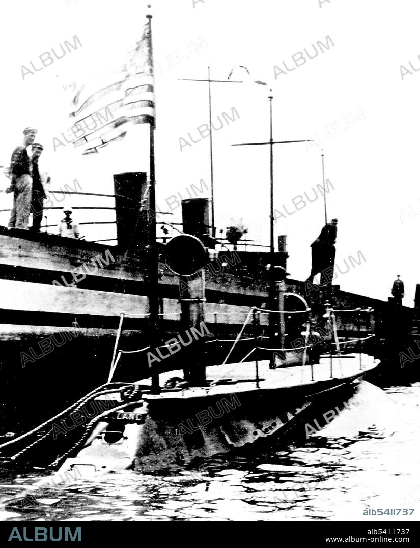 USS Holland at dock side during the early 1900s, with her nameplate visible just aft of the flagstaff. USS Holland (SS-1) was the U.S. Navy's first modern commissioned submarine. The boat was originally laid down as Holland VI at the Crescent Shipyard for John Holland's Holland Torpedo Boat Company, and launched in 1897. She was acquired by the USN in 1900. The US Government soon ordered more submarines, which were to be known as the Plunger class. These became America's first fleet of underwater naval vessels. U.S. Navy (cropped and cleaned).
