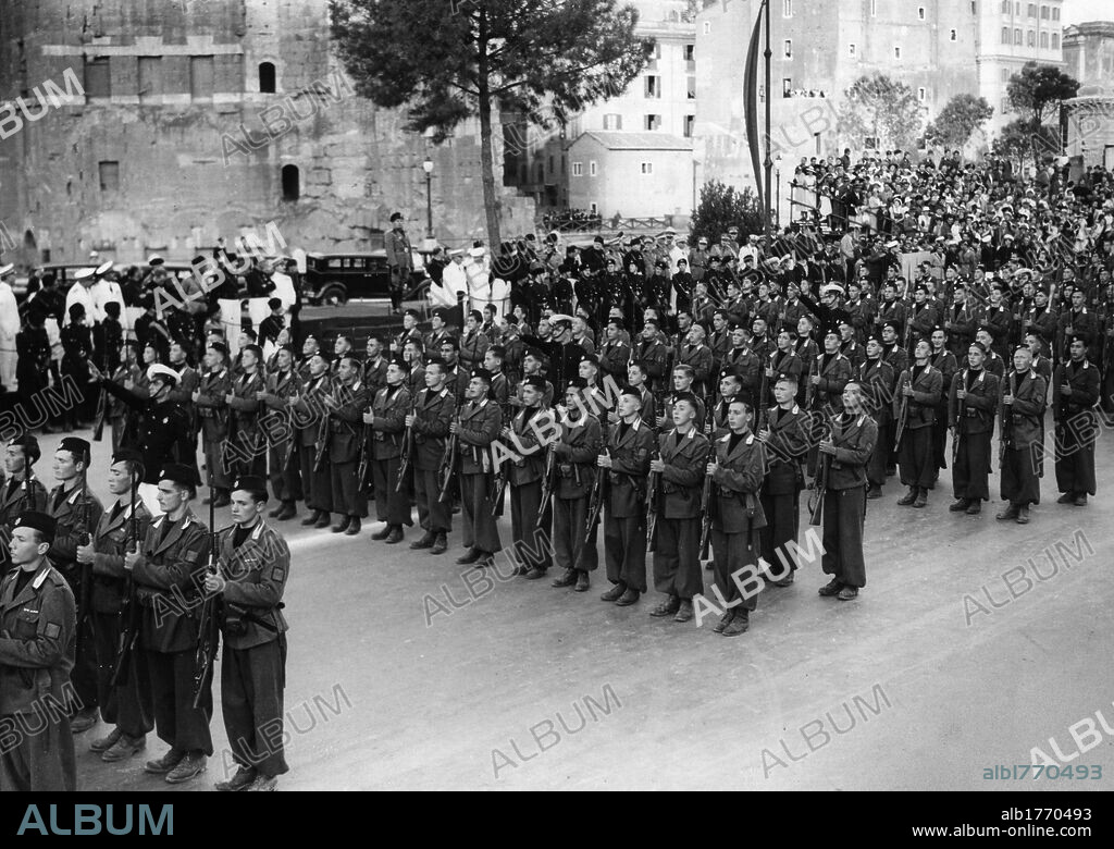 Mussolini during a parade of Avanguardisti. Head of Italian Government Benito Mussolini watching a parade of Avanguardisti (young Italian Fascists).
