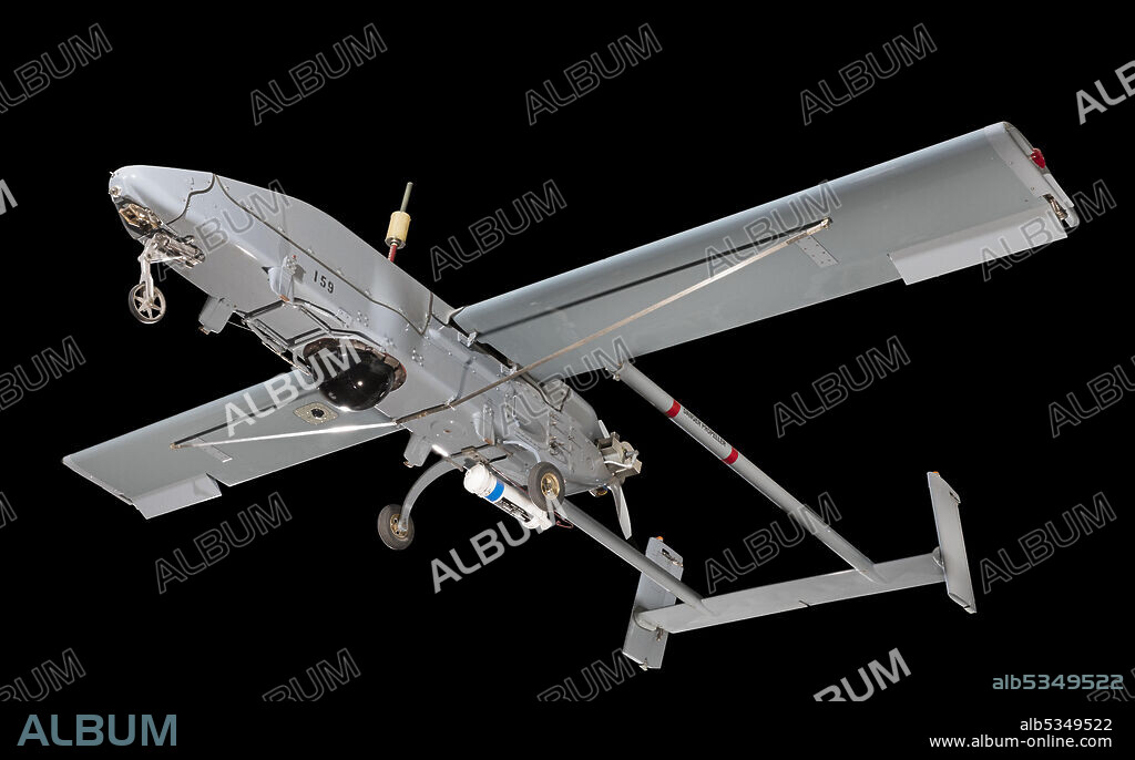 PIONEER UAV INC.. Unmanned Aerial Vehicle; Single engine; Pusher propeller; Twin tailbooms and rudders; Fixed tricycle undercarriage; Sensor package; Rocket assisted takeoff bottle included; Wings, tailbooms, tail assembly, and antenna breakdown for storage; Air Vehicle No. 159. The RQ-2A provides field commanders with real-time reconnaissance, surveillance, target acquisition, and battle damage information. Ground controllers pilot the aircraft over its 185-kilometer (115-mile) range. The RQ-2A can be recovered by flying into a large net aboard a ship or by using a tail hook and arresting wire on land. Its small size and composite materials make the RQ-2A difficult to detect visually and on radar. U.S. Army, Navy, and Marine units began using RQ-2As in the late 1980s. This one operated from the battleship Wisconsin during the 1991 Gulf War. While it was assessing damage from naval gunfire to targets on Faylaka Island near Kuwait City, several Iraqi soldiers signaled their intention to surrender to the aircraft during a low pass-the first time enemy soldiers had ever surrendered to an unmanned aerial vehicle. They were later captured by U.S. ground troops.