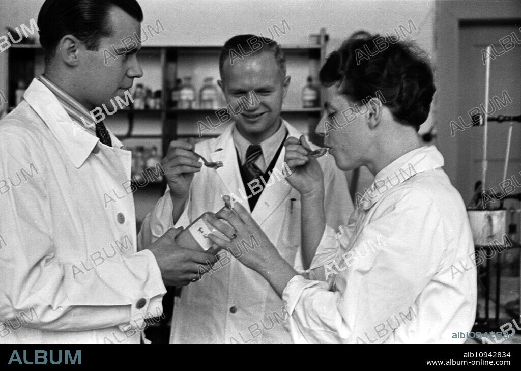 Sientific staff members of the Deutsche Fettsäurewerke and Maerkische Seifenindustrie company at Witten tasting margarine produced from coal, Germany 1930s.
