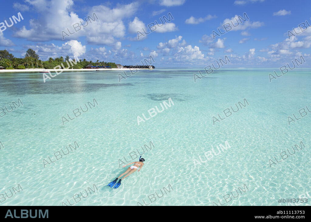 Woman snorkelling at Olhuveli Beach and Spa Resort, South Male Atoll, Kaafu Atoll, Maldives, Indian Ocean, Asia.