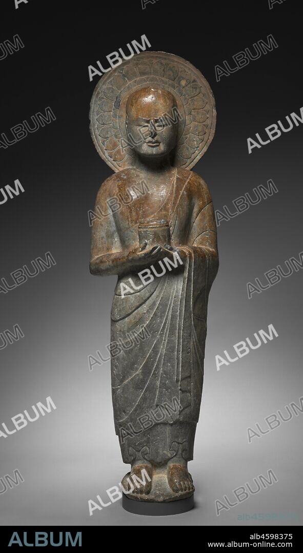 Standing Disciple Mahakasyapa Holding a Cylindrical Reliquary, c. 550. Mahakasyapa, the disciple of Shakyamuni, is presented with closed eyes in an expression of meditative concentration. He is holding a reliquary for the Buddha?s ashes, which symbolize the Buddha entering final spiritual attainment (nirvana) at death. The artistic simplicity exemplifies the spiritual content of this figure.