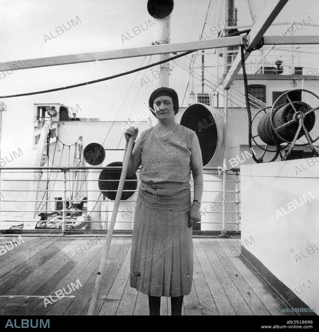 Playing shuffleboard on a Cunard Line cruise to the West Indies, January-March 1931. A woman passenger playing shuffleboard on the boat deck.