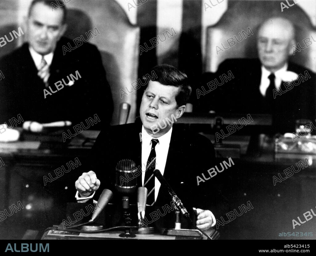 Kennedy Giving Historic Speech to Congress, 1961. President John F. Kennedy in his historic message to a joint session of the Congress, on May 25, 1961 declared, "...I believe this nation should commit itself to achieving the goal, before this decade is out, of landing a man on the Moon and returning him safely to the Earth." This goal was achieved when astronaut Neil A. Armstrong became the first human to set foot upon the Moon at 10:56 p.m. EDT, July 20, 1969. Shown in the background are, (left) Vice President Lyndon Johnson, and (right) Speaker of the House Sam T. Rayburn.