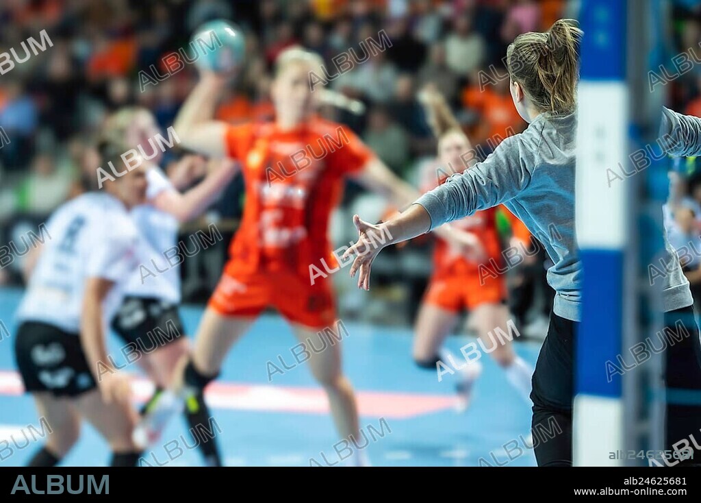 Detail of goalkeeper's hand and handball game in the background