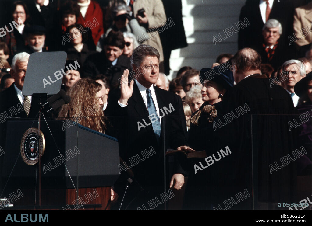 Bill Clinton, standing between Hillary Rodham Clinton and Chelsea Clinton, taking the oath of office of president of the United States, Washington, D.C., USA, Official White House Photograph, January 20, 1993.