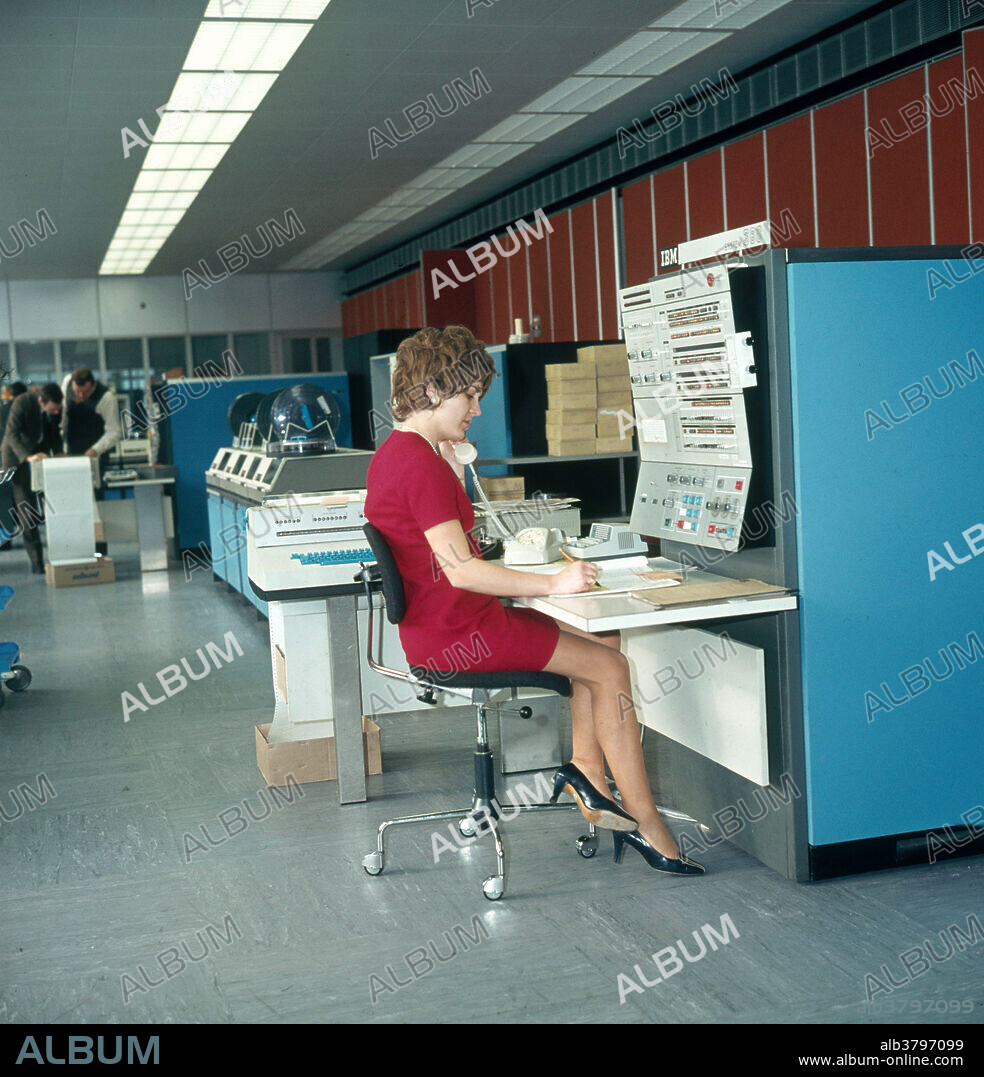 Historic image of a woman working on an early mainframe computer system, the IBM 360, which was released in 1964. The model #40 is shown here.