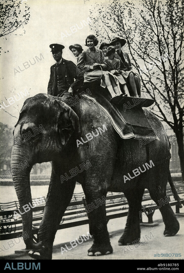'At the London Zoo - enjoying a ride on an elephant', 1939, (1947). The future Queen Elizabeth II rides an elephant with a keeper as mahout. From "Princess Elizabeth: The Illustrated Story of Twenty-one Years in the Life of the Heir Presumptive", by Dermot Morrah. [Odhams Press Limited, London, 1947].