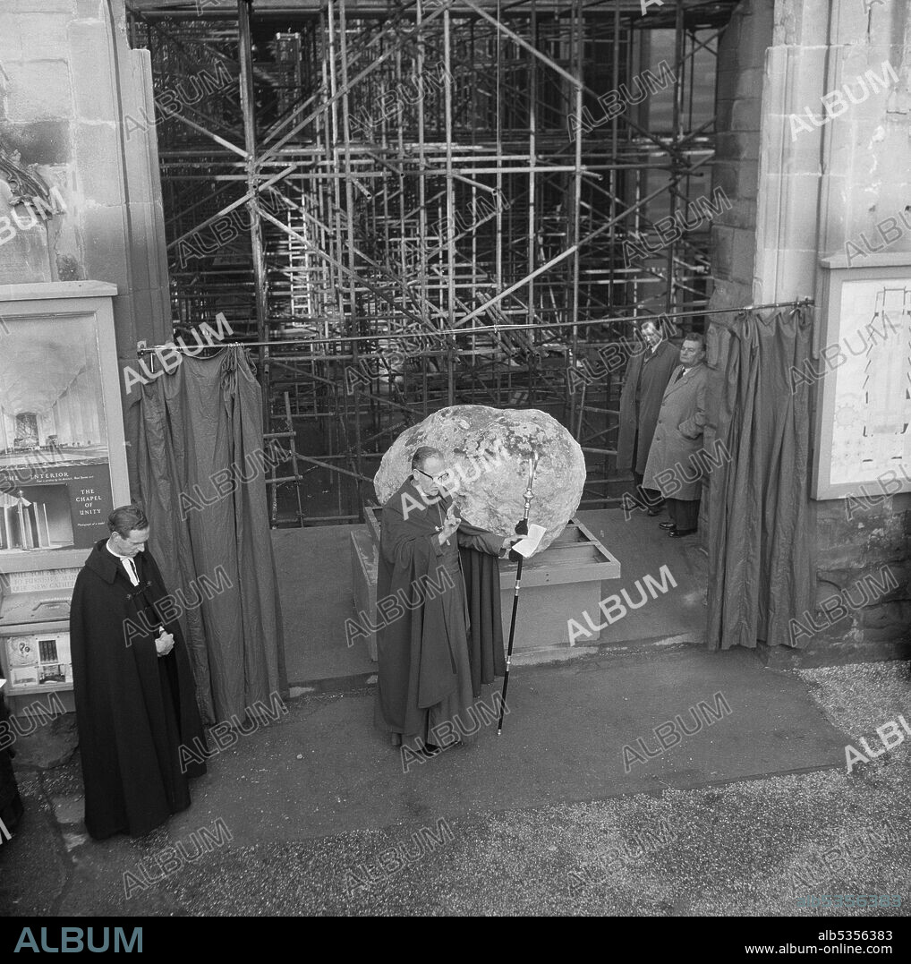 JOHN LAING PLC. The Bishop and Provost of Coventry Cathedral at the unveiling ceremony of the Boulder from Bethlehem. The boulder which was brought from a hillside in Bethlehem was transported to Coventry Cathedral to be used as its new font. Weighing three tons, it was transported to Manchester Docks in the SS Norman Prince and then on to Coventry. The unveiling ceremony took place on 22nd December 1960 and the boulder was unveiled by 7-year-old Henry Sumner, son of the foreman carpenter at Coventry Cathedral. The boulder was later moved to its current position in front of the baptistery window.