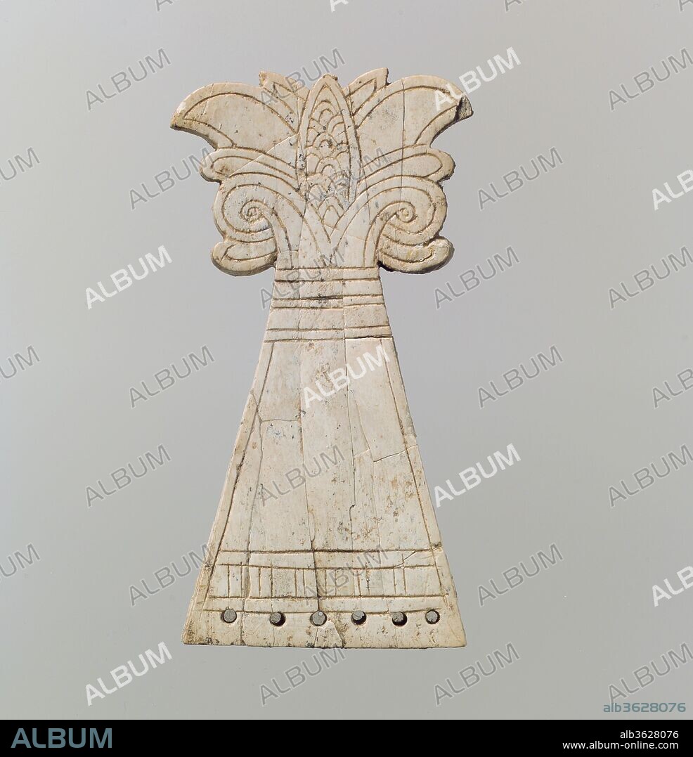 Incised horse frontlet carved into the shape of a flowering, volute palmette tree. Culture: Assyrian. Dimensions: 4.21 x 2.2 x 2.09 in. (10.69 x 5.59 x 5.31 cm). Date: ca. 9th-8th century B.C..
This ivory plaque is carved into the form of a flowering, voluted palmette emerging from a wide stalk. The crowning floral ornamentation includes volutes, leaves, and a central, oval bud, all outlined with incision. The stalk is ornamented with two blank bands just below the floral capital, with an additional, fringed band bordering the lower edge. The six holes drilled into the lower edge of this piece and suggest that it was fastened to another material, perhaps a textile or leather backing that has not survived. Originally, this piece was probably used as a frontlet, an equestrian bridle-harness ornament which adorned a horse's forehead. Over two hundred ivory and gypsum alabaster equestrian bridle-harness ornaments have been found at Nimrud. The majority, including this frontlet, were found in a large storeroom (Room SW 37) at Fort Shalmaneser, a royal building at Nimrud that was probably used to store tribute and booty collected by the Assyrians while on military campaign. Although horses wearing equestrian bridle-harness ornaments are shown in Neo-Assyrian palace reliefs, it is not possible to know whether the ornaments in the reliefs were meant to represent work in ivory or in more durable materials such as bronze or iron. Ivory pieces like this one may have been used ceremonially, as votive dedications, or as processional regalia, rather than in battle. 
Built by the Assyrian king Ashurnasirpal II, the palaces and storerooms of Nimrud housed thousands of pieces of carved ivory. Most of the ivories served as furniture inlays or small precious objects such as boxes. While some of them were carved in the same style as the large Assyrian reliefs lining the walls of the Northwest Palace, the majority of the ivories display images and styles related to the arts of North Syria and the Phoenician city-states. Phoenician style ivories are distinguished by their use of imagery related to Egyptian art, such as sphinxes and figures wearing pharaonic crowns, and the use of elaborate carving techniques such as openwork and colored glass inlay. North Syrian style ivories tend to depict stockier figures in more dynamic compositions, carved as solid plaques with fewer added decorative elements. However, some pieces do not fit easily into any of these three styles. Most of the ivories were probably collected by the Assyrian kings as tribute from vassal states, and as booty from conquered enemies, while some may have been manufactured in workshops at Nimrud. The ivory tusks that provided the raw material for these objects were almost certainly from African elephants, imported from lands south of Egypt, although elephants did inhabit several river valleys in Syria until they were hunted to extinction by the end of the eighth century B.C.