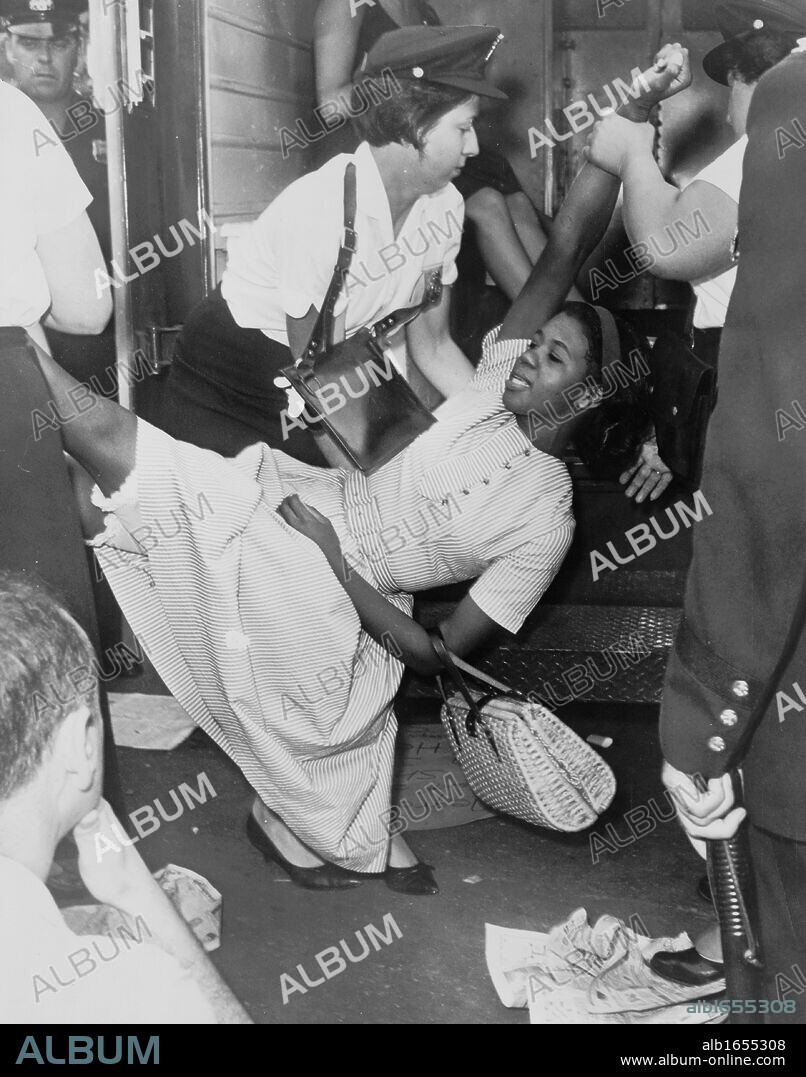 African American woman being carried to police patrol wagon during demonstration in Brooklyn, New York. 1963. World Telegram & Sun photograph by Dick DeMarsico.