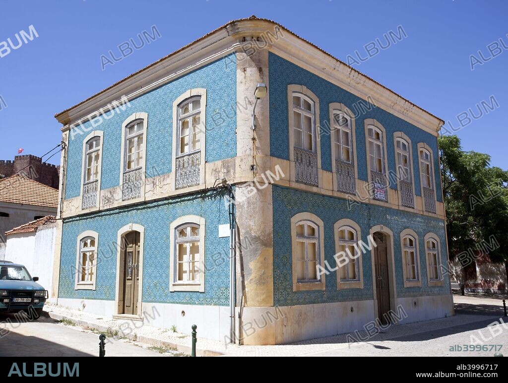 A blue house, Silves, Portugal, 2009. Silves  is a town on the Portuguese Algarve, in the district  of Faro. It is located near a Roman bridge over the Ribeira de Arade and thus controls the river valley down to the coast. The town was occupied by the Moors in 713 and became part of the Ummayad kingdom under the Arabic name of Shilb. In the 10th century, it was one of the most important towns of western Al-Andalus. Silves became an independent taifa in 1027.