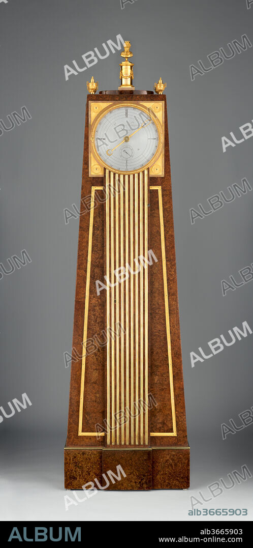 Obelisk clock with a Franklin movement. Artist: Clockmaker: Peter Kinzing (German, 1745-1816). Culture: German, Neuwied am Rhein. Dimensions: Overall: 75 × 21 1/8 × 7 5/8 in. (190.5 × 53.7 × 19.3 cm). Maker: Case maker: David Roentgen (German, Herrnhaag 1743-1807 Wiesbaden, master 1780). Date: ca. 1785-90.
The unusual obelisk shape of this case accommodates the swing of the pendulum and reflects the new taste for ancient Egyptian art, or "Egyptomania," in Europe at the time. The finial at the top of the clock is, fittingly, in the form of the double-faced head of Janus, the Roman god of beginnings and endings. The simplified movement--consisting of just three wheels, a four-hour spiral-ring dial, and a single minute hand--was invented by Benjamin Franklin in the 1760s or 1770s. Franklin may have come in contact with cabinetmaker David Roentgen and clockmaker Peter Kinzing while in Paris. Kinzing improved upon Franklin's original model: the addition of a small pointer, seen through an aperture in the minute hand, allowed for a clearer determination of the correct hour. Though Franklin intended for his simplified movement to be used in economically produced clocks, here it has been employed for one of the most luxurious. The dial is made of solid silver--an extremely rare and expensive feature for any clock.