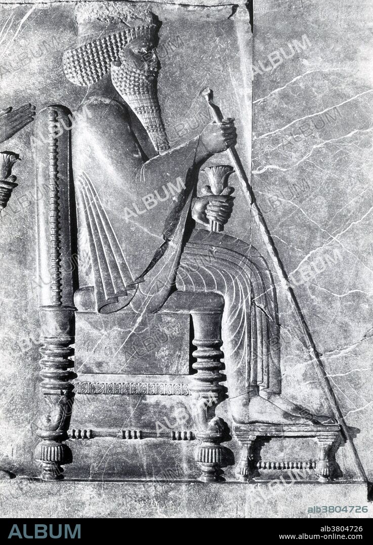 Relief carving of Darius on his throne, holding a scepter and lotus, and receiving the delegations of the Empire, in Persepolis, Iran. Darius I (550-486 BC) was the third king of the Persian Achaemenid Empire. He ruled the empire at its peak, when it included much of West Asia, the Caucasus, parts of the Balkans, most of the Black Sea coastal regions, parts of the North Caucasus, Central Asia, as far as the Indus Valley in the far east, and portions of north and northeast Africa including Egypt, eastern Libya and coastal Sudan. Darius organized the empire by dividing it into provinces and placing satraps to govern it. He organized a new uniform monetary system, along with making Aramaic the official language of the empire. He also put the empire in better standing by building roads and introducing standard weights and measures. He had the cliff-face Behistun Inscription carved to record his conquests, an important testimony of the Old Persian language. The Achaemenid Empire during Darius' reign controlled the largest fraction of the world's population of any empire in history. Based on historical demographic estimates, Darius I ruled over approximately 50 million people, or at least 44% of the world's population.