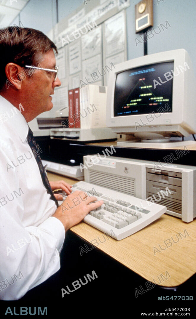 Scientist analyzing data on computer screen ca. 1996.