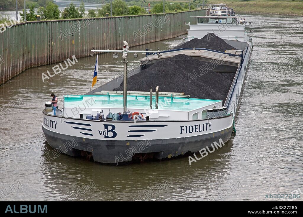 Barge transporting coal on Mosel River, Germany.