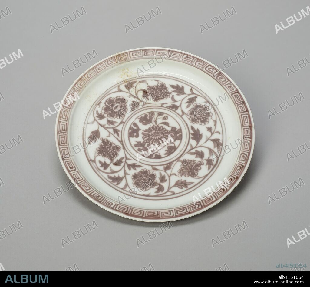 Shallow Dish with Peony Scrolls, Chrysanthemum Sprays, and Key-Fret Border; Lotus Panels Panels Under Rim. China. Date: 1368-1388. Dimensions: H. 2.4 cm (15/16 in.); diam. 19.6 cm (7 3/4 in.). Porcelain painted in underglaze blue. Origin: China.