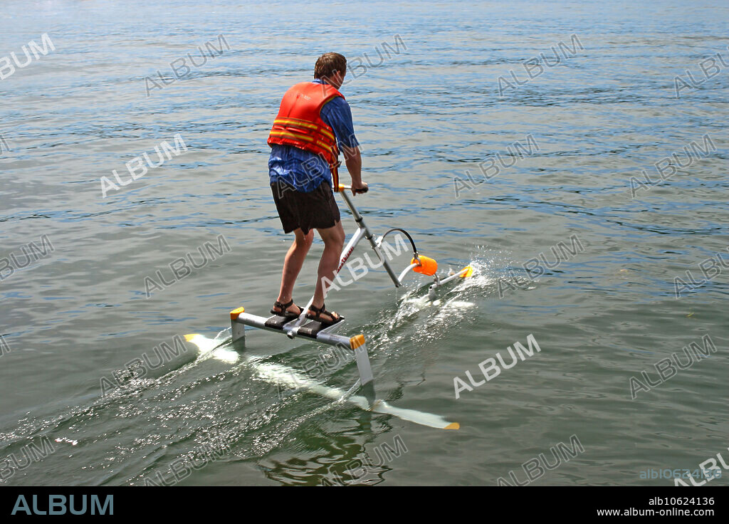 A human powered hydrofoil design is tested in a fresh water lake. This device uses a bouncing motion to propel the rider through the water at speeds up to 15 miles per hour. The device requires about as much effort as a runner sprinting.