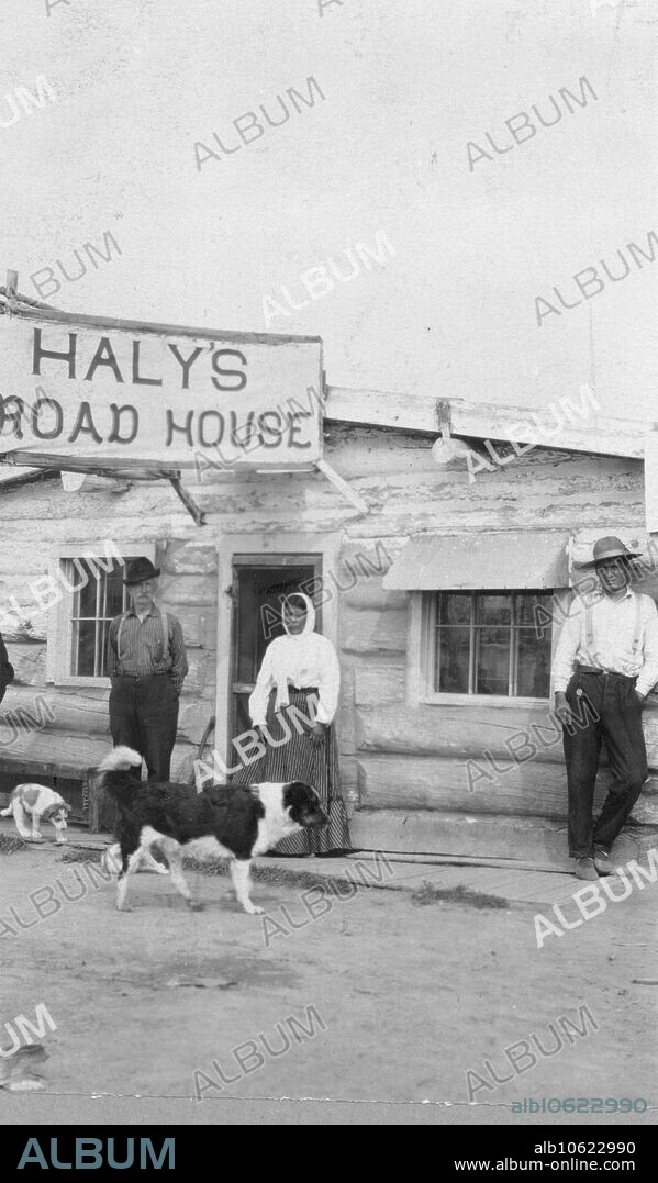 Jim Haly and his squaw, between c1900 and 1916. People and dogs in front of Haly's Road House.