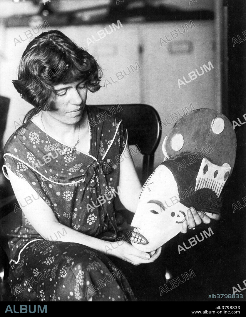 Margaret Mead (1901-1978), an American cultural anthropologist, with a mask. Mead received her undergraduate degree from Barnard University in 1923, where she studied under Franz Boaz and Ruth Benedict. She acquired a Ph.D from Columbia University in 1929. At the age of 23, Dr. Mead began a field study in Samoa, against Boaz's advice. From this experience she wrote "Coming Of Age In Samoa," published in 1928. She became curator at the Department of Anthropology at the American Museum of Natural History and was a professor of anthropology at Columbia University. She is quoted as saying: "I have spent most of my life studying the lives of other peoples, faraway peoples, so that Americans might better understand themselves.".