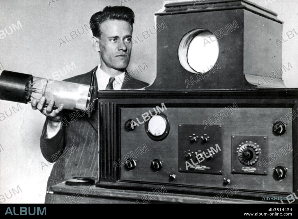 Editorial use only . Captioned: Farnsworth holding his dissector tube, and displaying his revolutionary new television, San Francisco, California, August 10, 1929. Philo Taylor Farnsworth (1906-1971) was an American inventor and television pioneer. He made many contributions that were crucial to the early development of television, but is remembered for inventing the first fully functional all-electronic image pickup device (video camera tube). He called it the image dissector and it was the first fully functional and complete all-electronic television system. Farnsworth developed a television system complete with receiver and camera, which he produced commercially in the form of the Farnsworth Television and Radio Corporation, from 1938 to 1951. He held 165 patents, mostly in radio and television. In 1999, TIME magazine included Farnsworth in The TIME 100: The Most Important People of the Century.