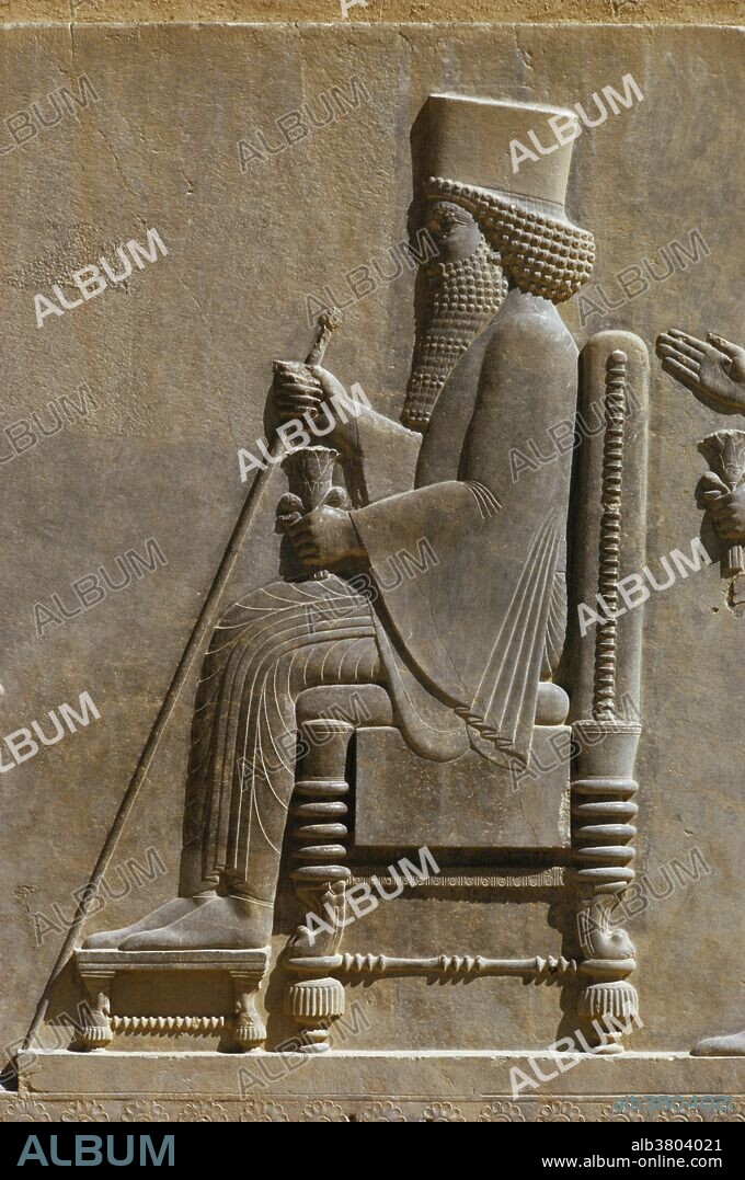 Relief carving of Darius the Great on his throne, holding a sceptre and lotus, in the treasury at Persepolis, Iran. Persepolis was the ceremonial capital of the Persian Empire ca. 550-330.