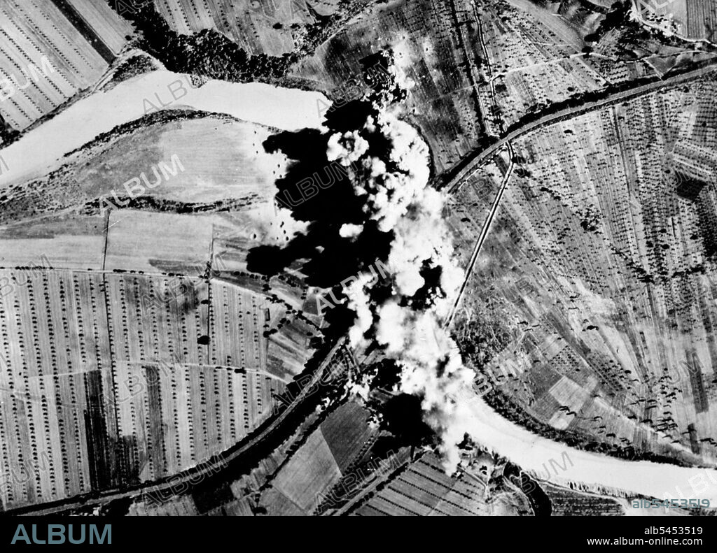 U.S. Bombers Destroy German Bridge in ItalySmoke billows up form bomb bursts covering this German-held railway bridge at Orvio, Italy, a town 45 miles northwest of Rome. A squadron of U.S. Army B-25 Marauder medium bombers blasted in the bridge during a raid over German communication lines in the area. February 14, 1944.