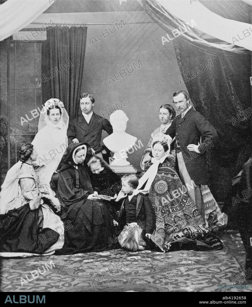 Queen Victoria and her family, Windsor, 1863. Photograph from a Royal Family album at Osborne House, Isle of Wight. Photograph possibly taken at the time of the Prince of Wales' marriage, with the family arranged around a bust of Albert, the late Prince Consort. Standing (left to right) - Princess Alexandra of Denmark, Princess of Wales (1844- 1925); Prince Albert Edward, Prince of Wales (1841-1910); Princess Helena (1846-1923): Grand Duke Louis of Hesse (1837-1892).In front (left to right) - Princess Alice (1843-1878); Queen Victoria (1819-1901); Princess Beatrice (1857-1944); Prince Leopold (1853-1884); possibly Crown Princess of Prussia (1840-1901).